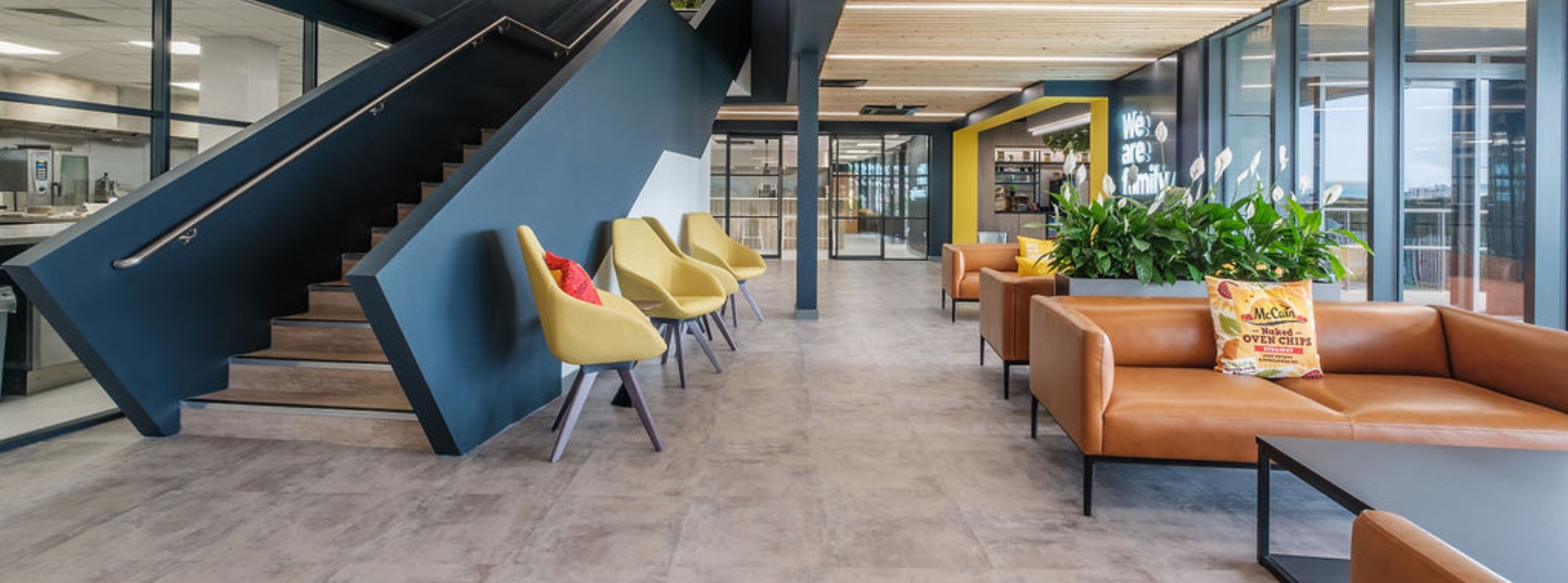 McCain Scarborough entrance with brown sofas and branded pillows